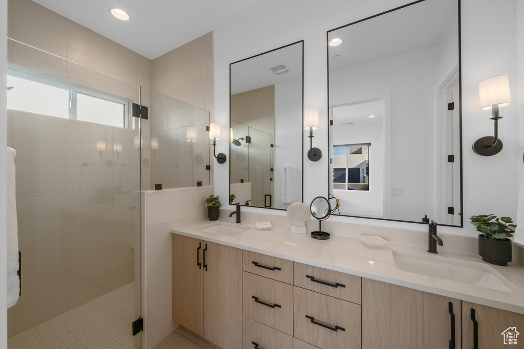 Bathroom with vanity and a shower with door