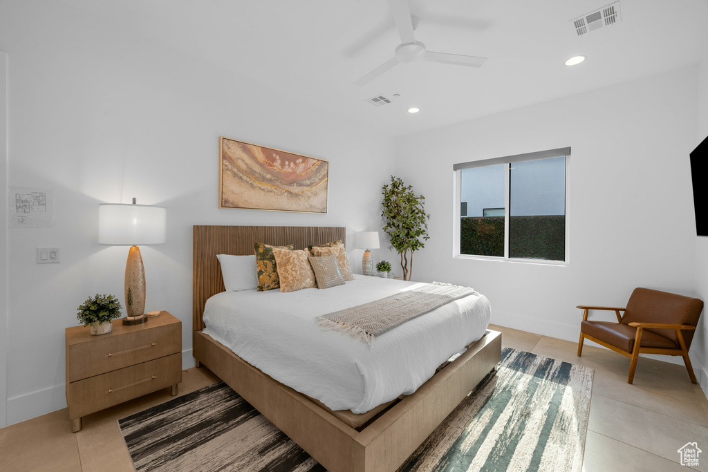 Tiled bedroom featuring ceiling fan