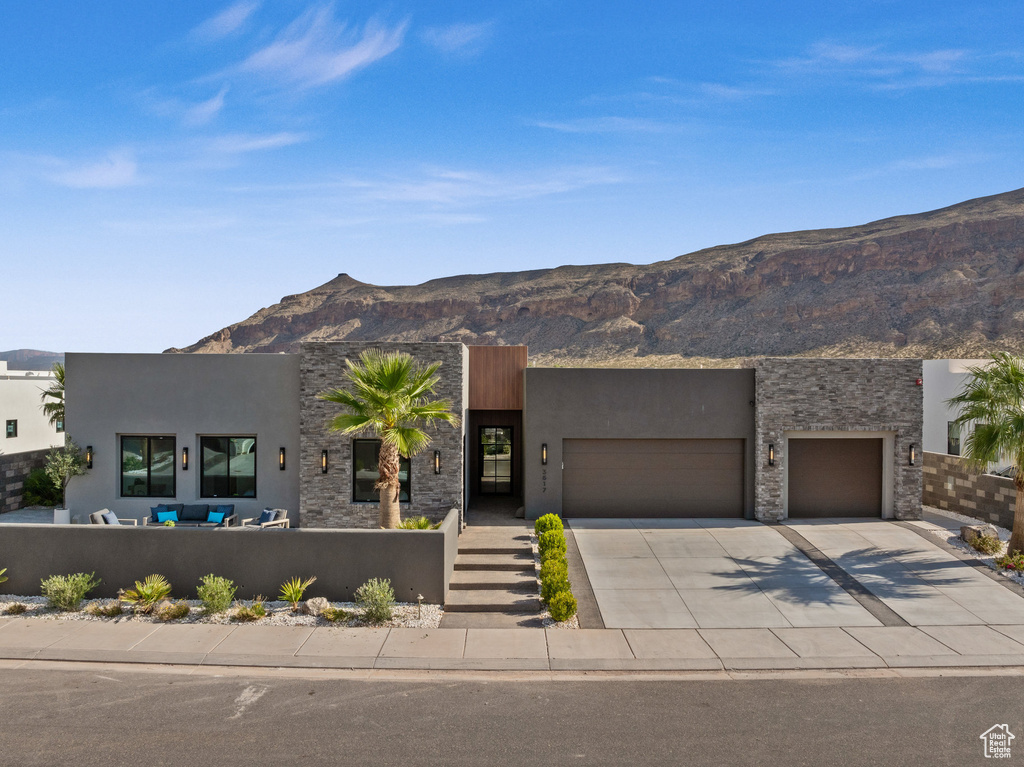 View of front facade featuring a mountain view and a garage