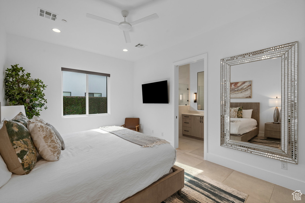 Tiled bedroom with ceiling fan and connected bathroom