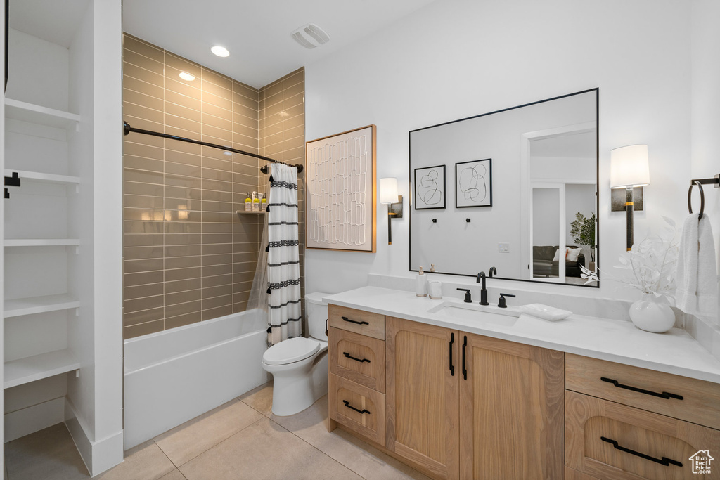 Full bathroom featuring shower / bath combination with curtain, toilet, tile patterned flooring, and vanity