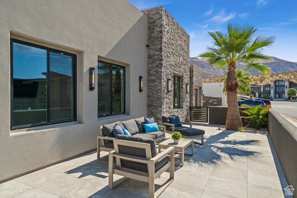 View of patio / terrace featuring a mountain view and an outdoor living space