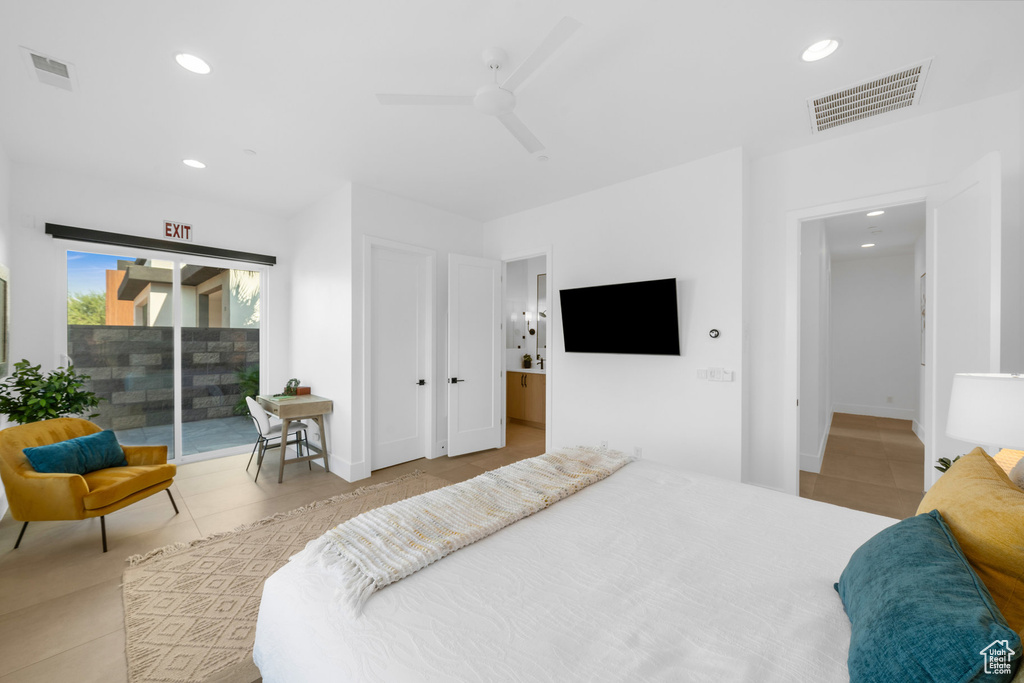 Bedroom featuring ceiling fan, light tile patterned flooring, connected bathroom, and access to exterior