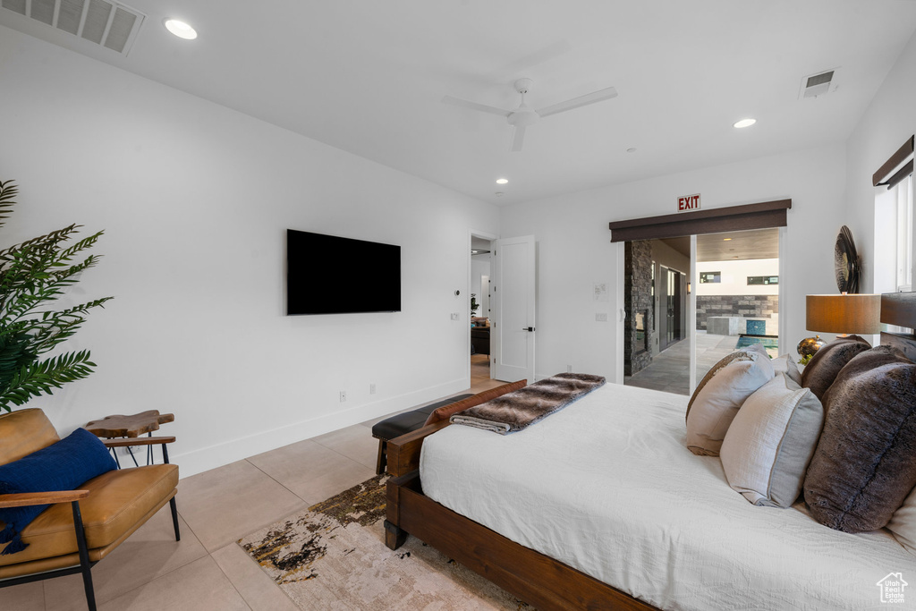 Tiled bedroom featuring access to outside and ceiling fan