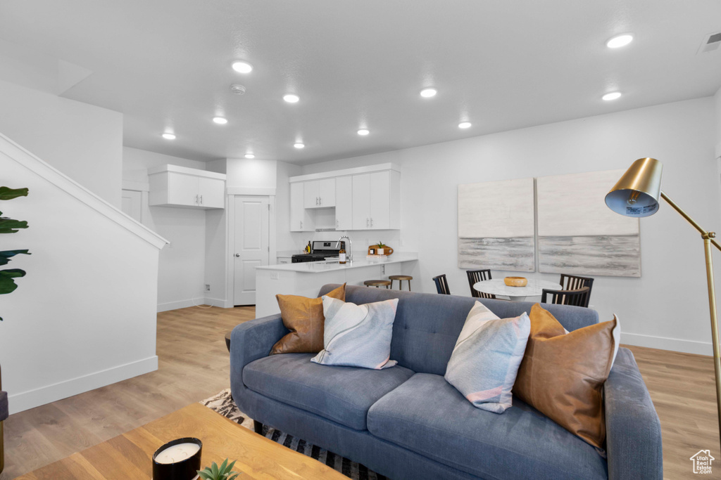 Living room with light hardwood / wood-style floors