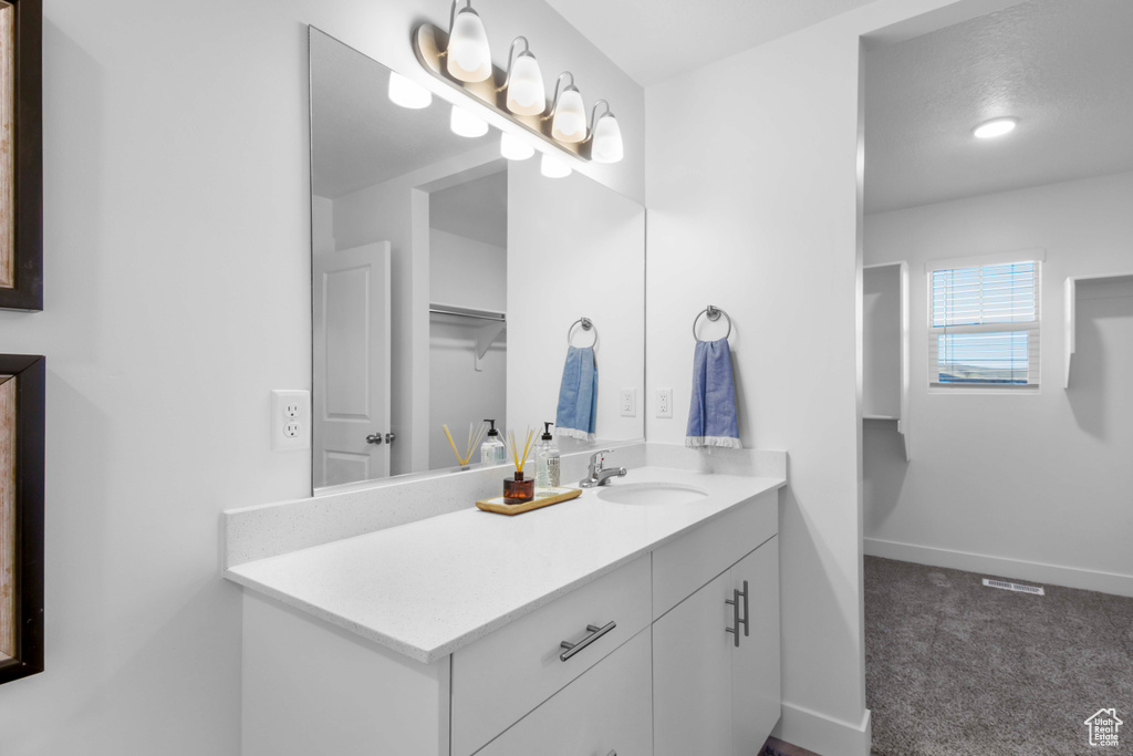 Bathroom with vanity and a textured ceiling