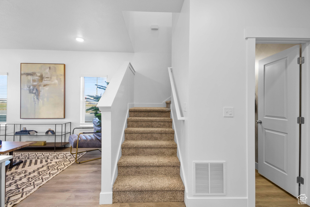 Stairway featuring wood-type flooring