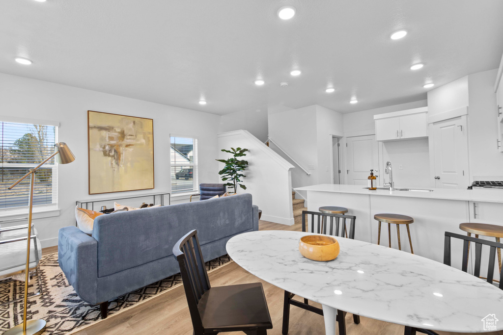 Dining area with a wealth of natural light and light hardwood / wood-style floors