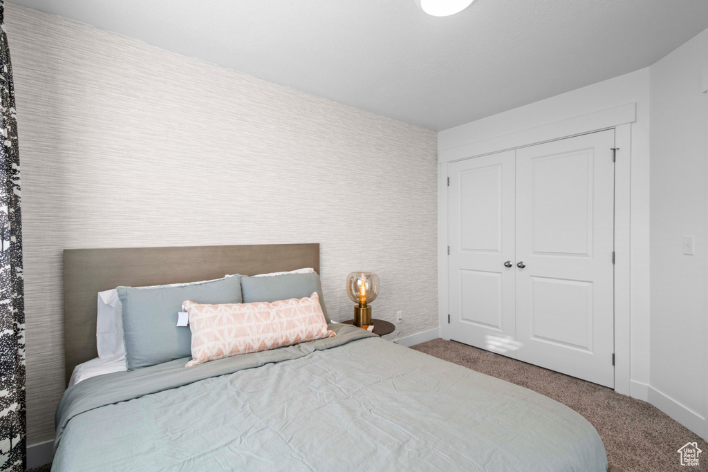 Bedroom featuring carpet floors and a closet