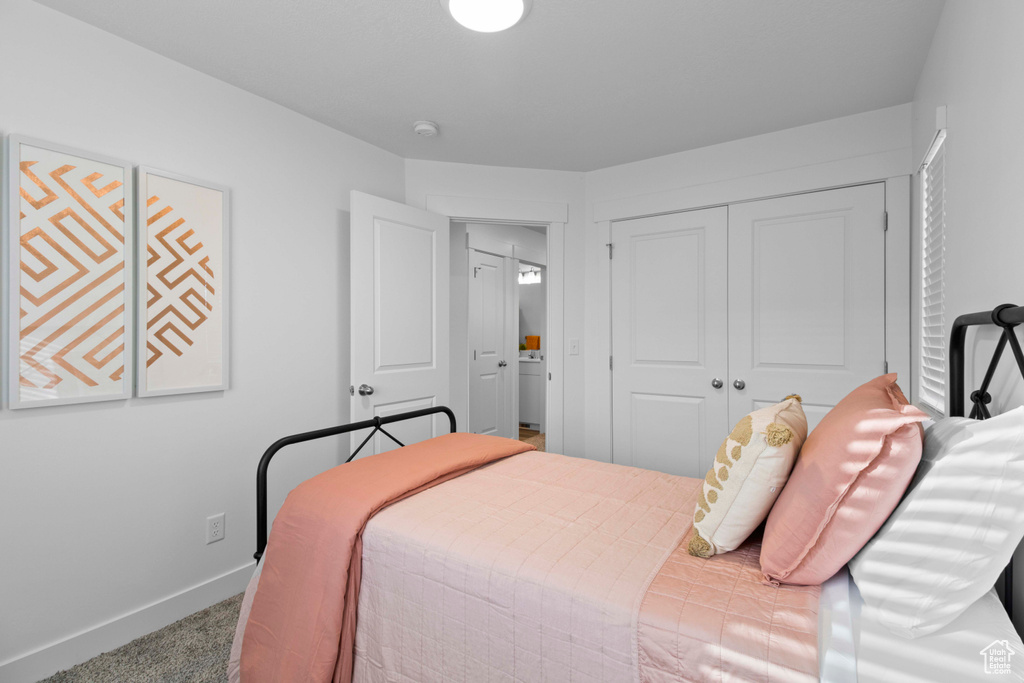 Bedroom featuring carpet floors and a closet