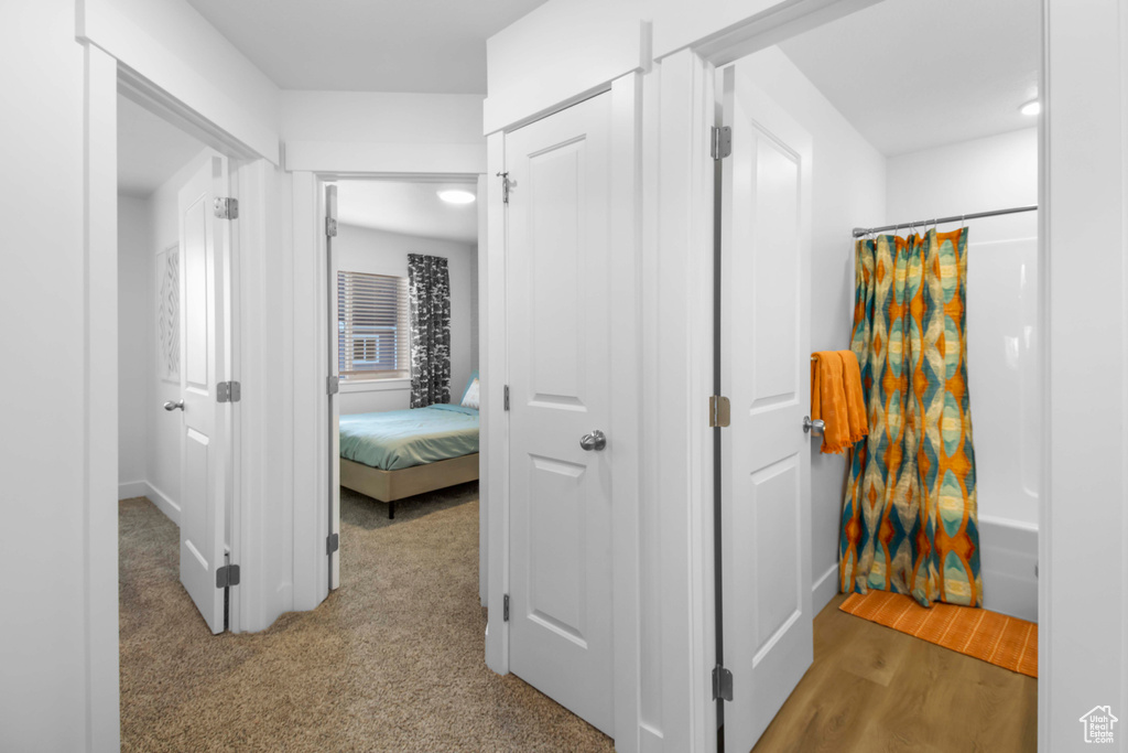 Hallway with light hardwood / wood-style floors