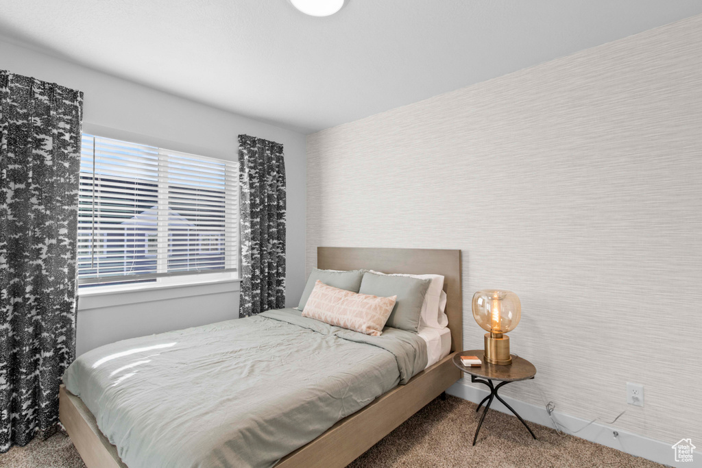 Bedroom featuring light carpet