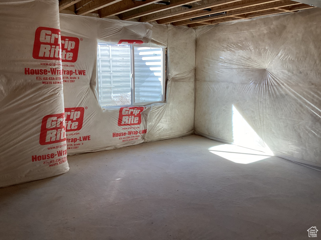 Unfurnished room featuring concrete flooring