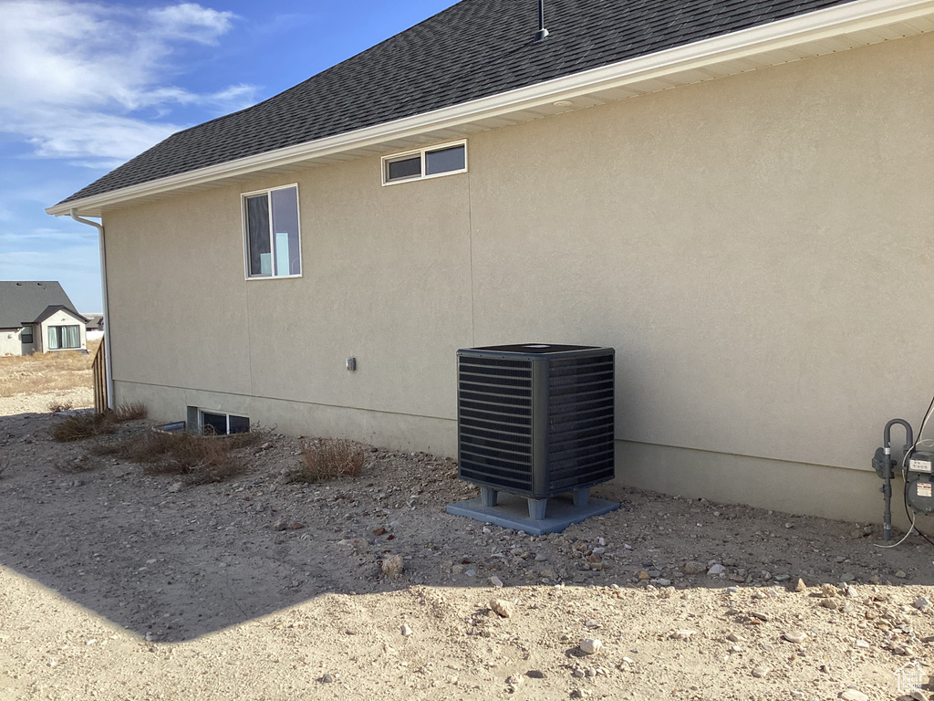 View of home's exterior featuring cooling unit