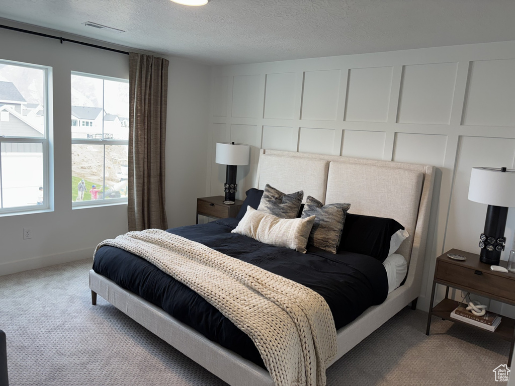 Carpeted bedroom featuring a textured ceiling