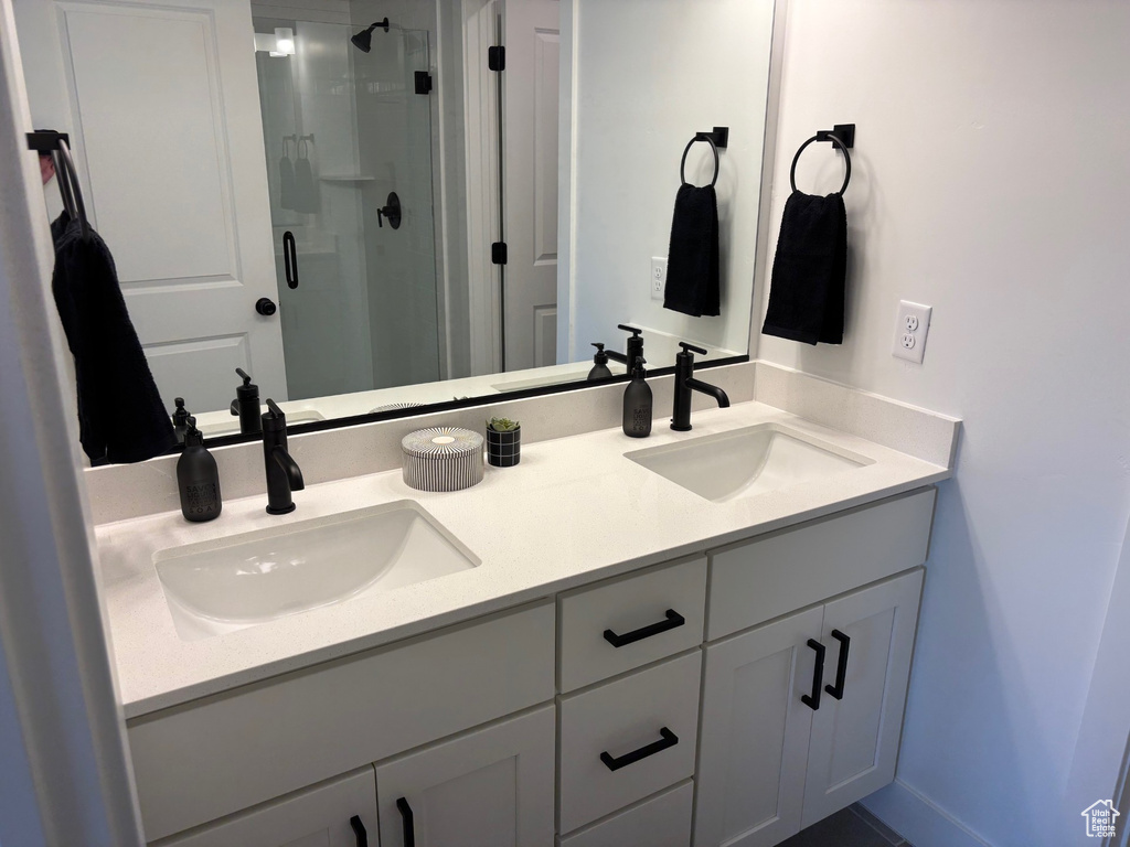 Bathroom featuring walk in shower and vanity