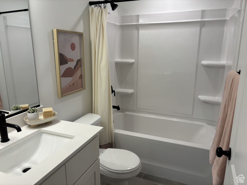 Full bathroom featuring tile patterned floors, vanity, shower / tub combo with curtain, and toilet