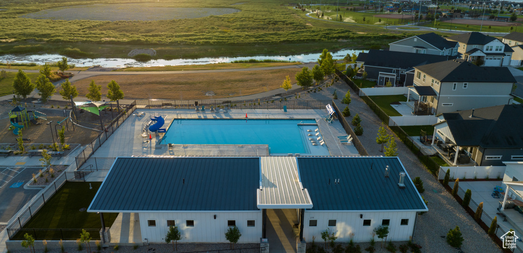 Birds eye view of property with a water view