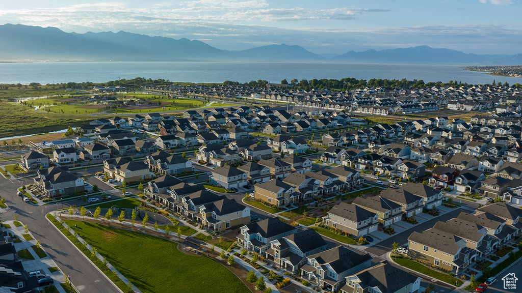 Drone / aerial view featuring a water and mountain view