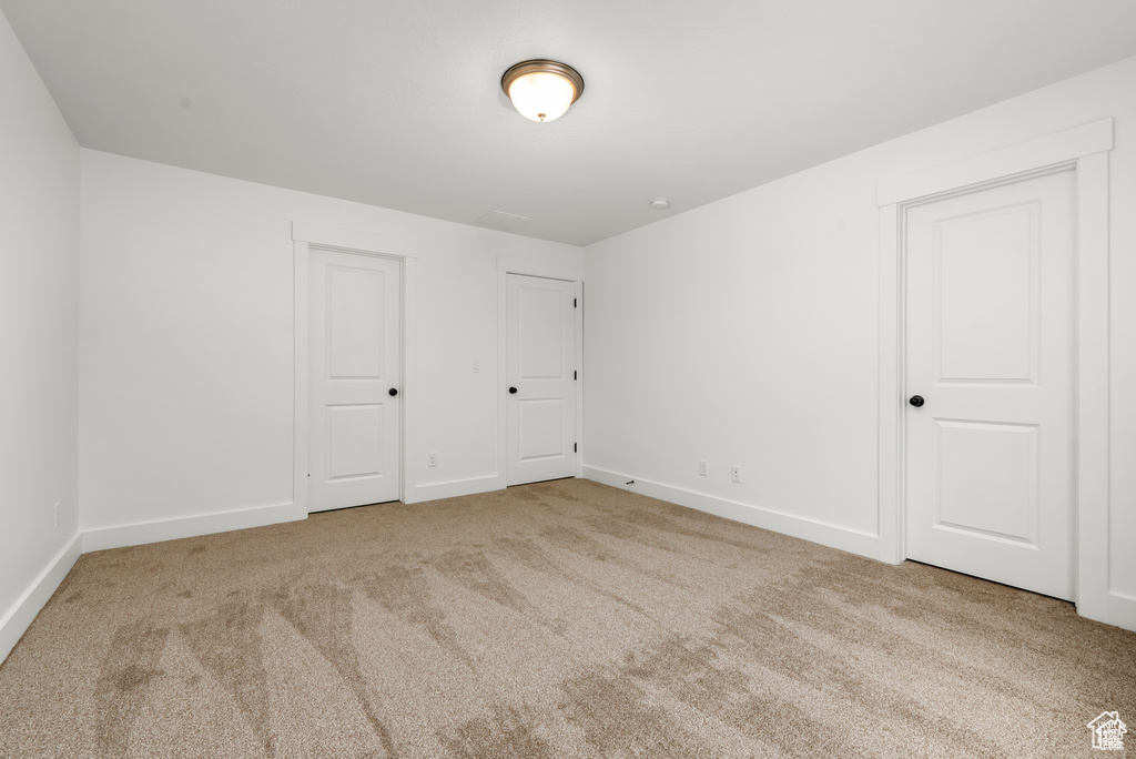 Spare room with light colored carpet