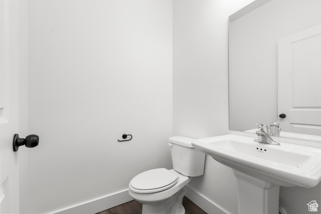 Bathroom featuring toilet and wood-type flooring