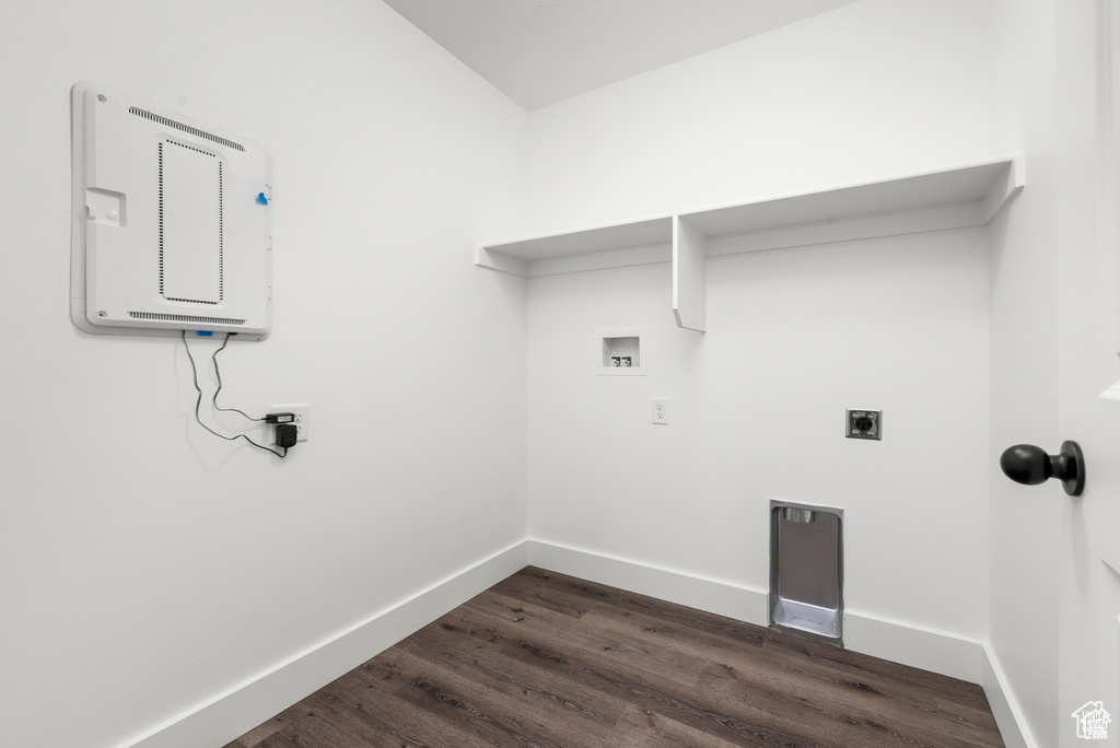 Laundry room featuring hookup for a washing machine, dark hardwood / wood-style flooring, and electric dryer hookup