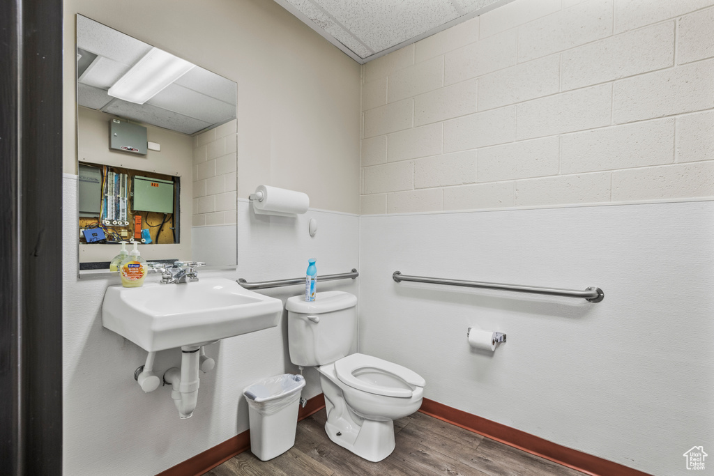 Bathroom featuring wood-type flooring and toilet