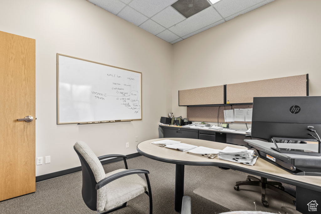 Office area with a paneled ceiling and carpet