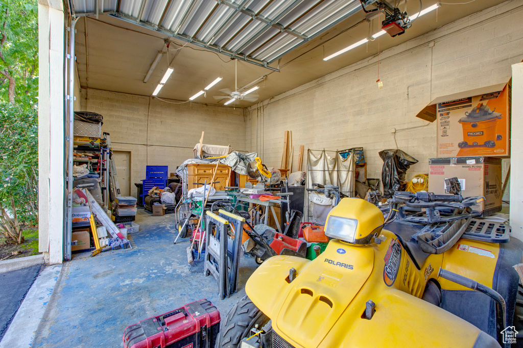 Garage with ceiling fan and a garage door opener