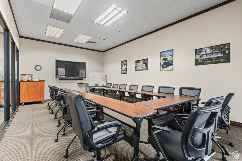 Carpeted office space with ornamental molding