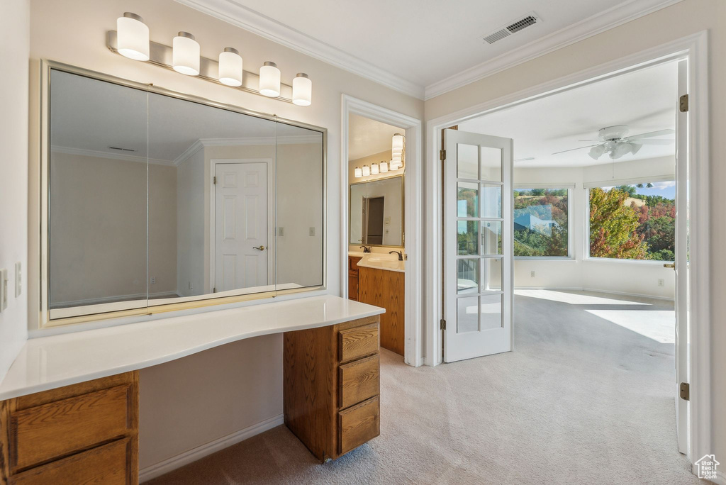 Bathroom with ornamental molding, ceiling fan, and vanity