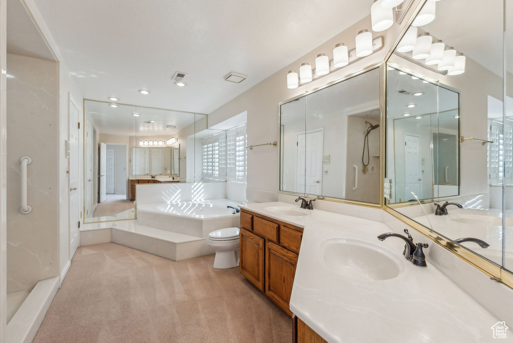 Full bathroom featuring independent shower and bath, vanity, and toilet