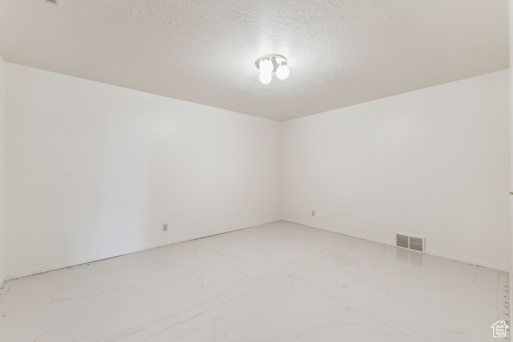 Unfurnished room with a textured ceiling