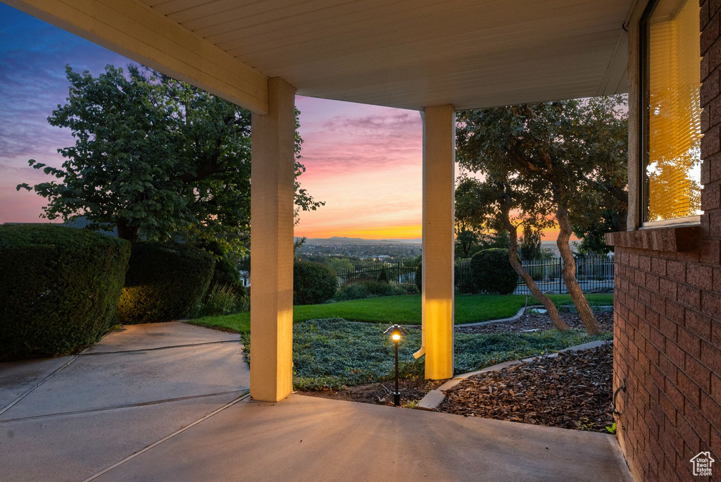 Patio terrace at dusk with a lawn