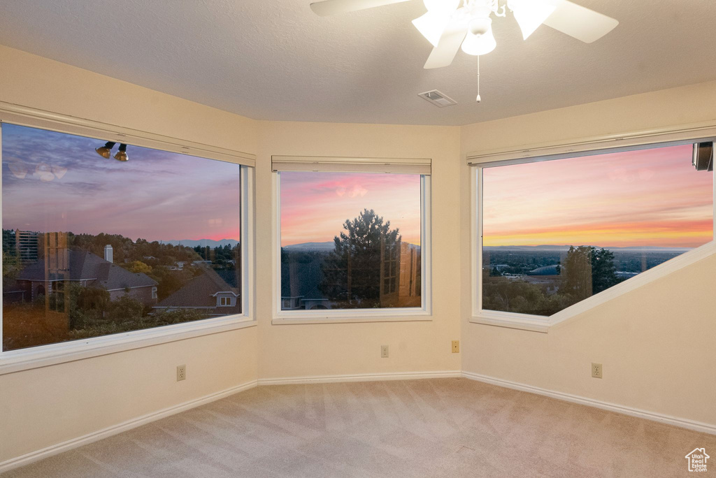 Spare room with light carpet and ceiling fan