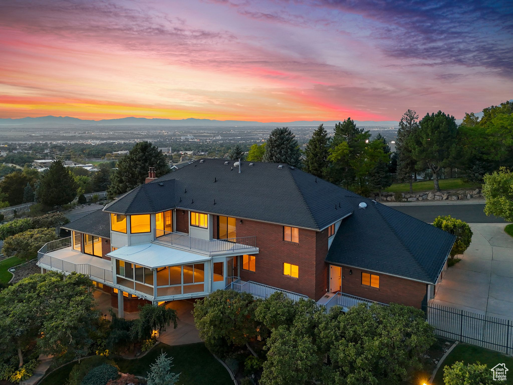 Back house at dusk with a balcony