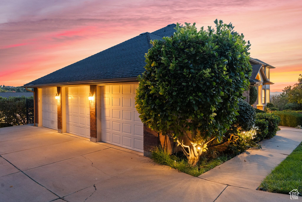 View of garage at dusk