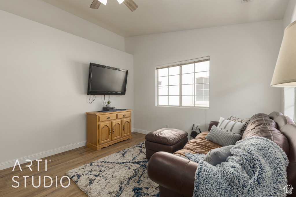 Living room featuring lofted ceiling, light hardwood / wood-style floors, and ceiling fan