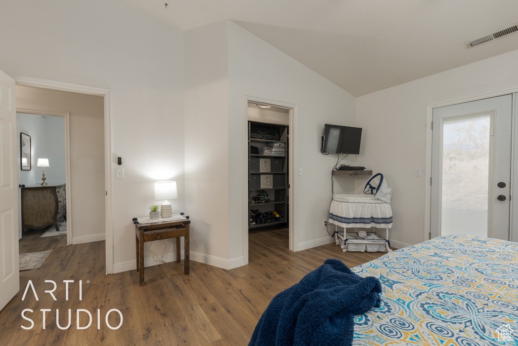 Bedroom featuring a closet, lofted ceiling, hardwood / wood-style floors, and a spacious closet