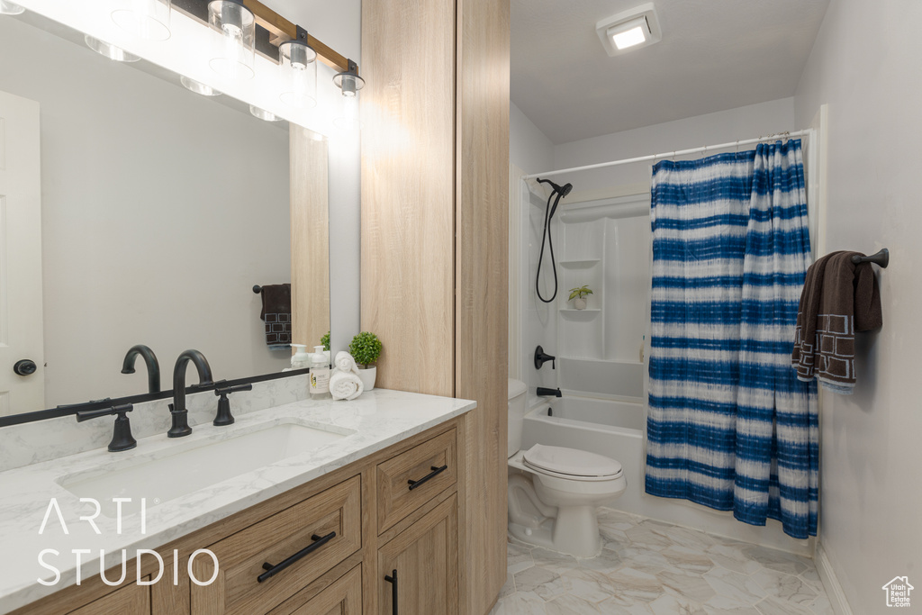 Full bathroom with shower / bathtub combination with curtain, vanity, and toilet