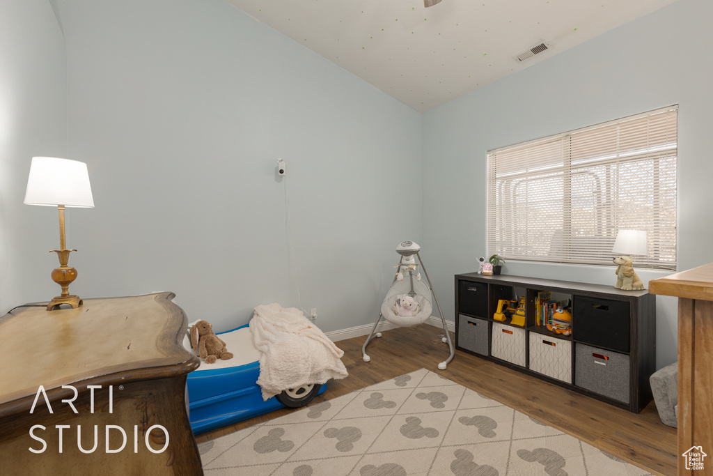 Bedroom featuring vaulted ceiling and hardwood / wood-style floors