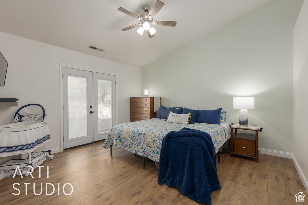 Bedroom featuring access to outside, ceiling fan, french doors, dark hardwood / wood-style floors, and vaulted ceiling