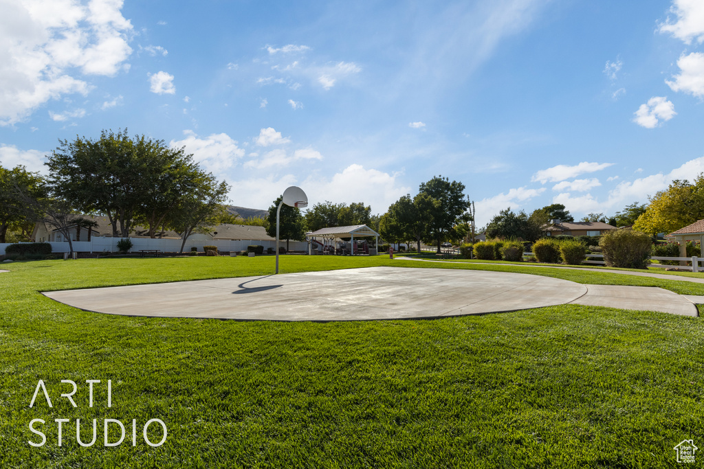 View of basketball court with a yard