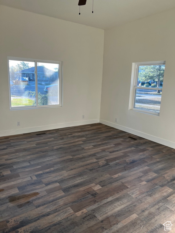 Spare room with ceiling fan and dark hardwood / wood-style floors