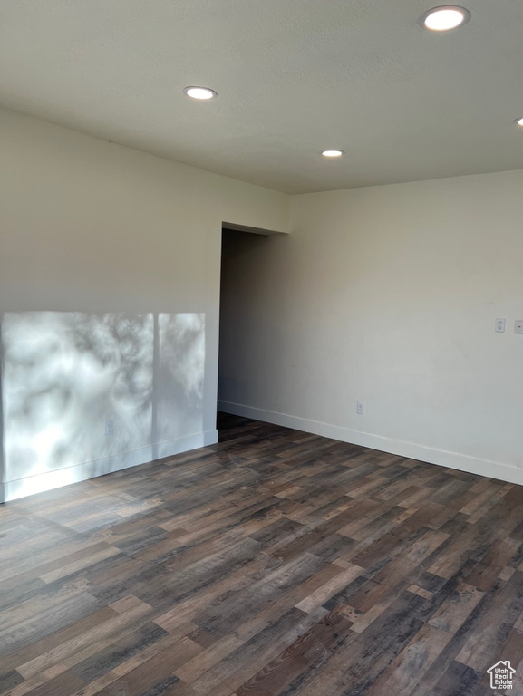 Unfurnished room with dark hardwood / wood-style flooring