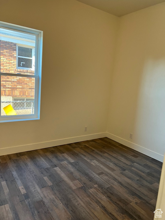 Spare room featuring dark hardwood / wood-style floors