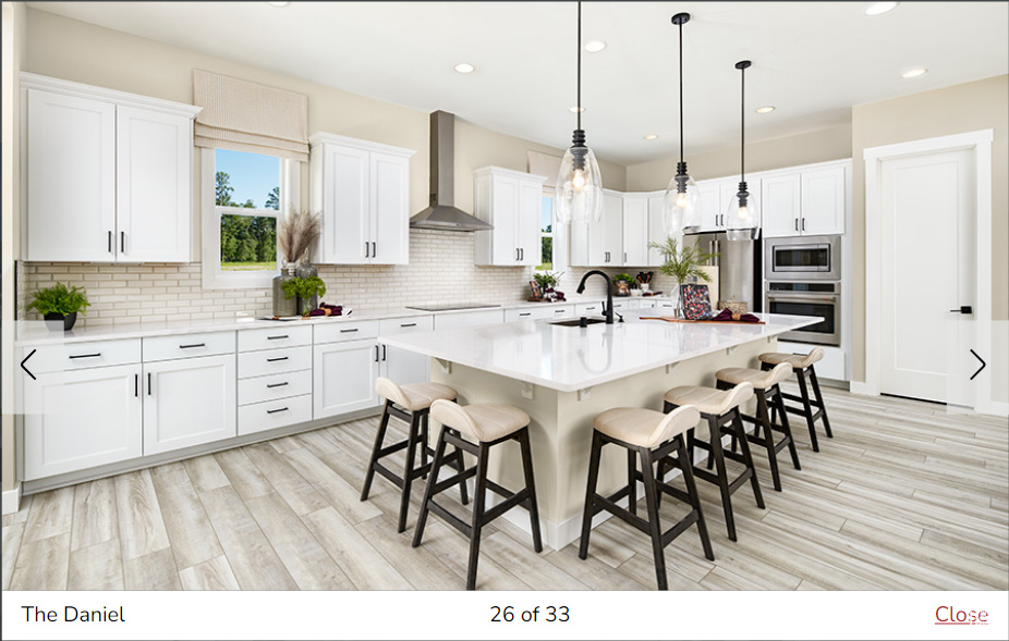 Kitchen featuring stainless steel appliances, an island with sink, white cabinets, and wall chimney exhaust hood