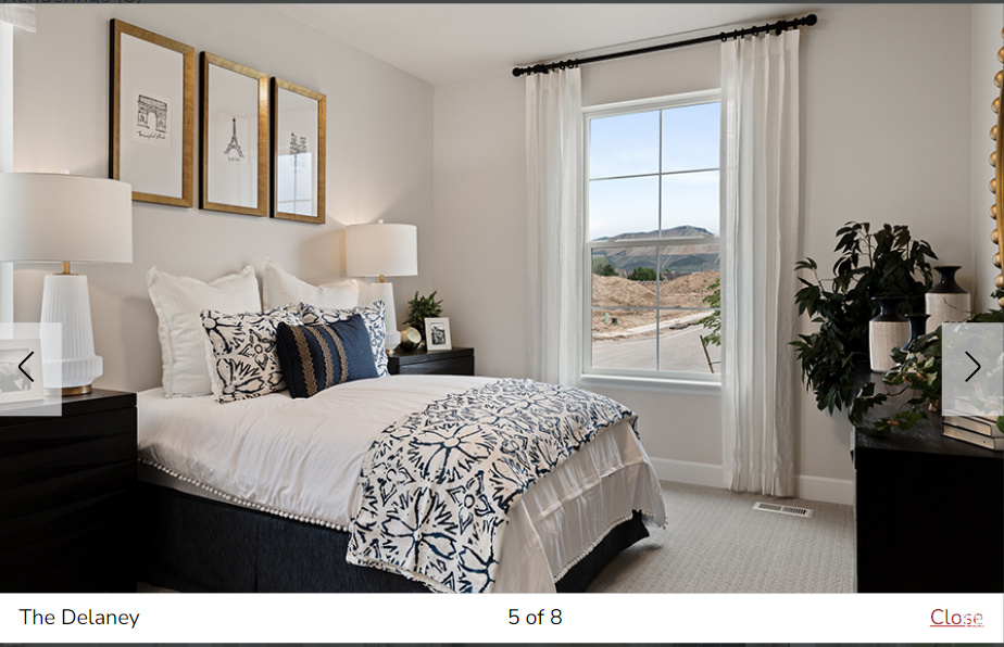 Bedroom featuring light carpet