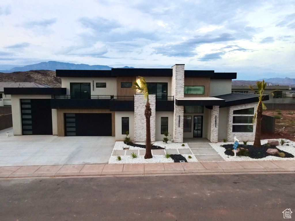 View of front of home featuring a mountain view and a garage