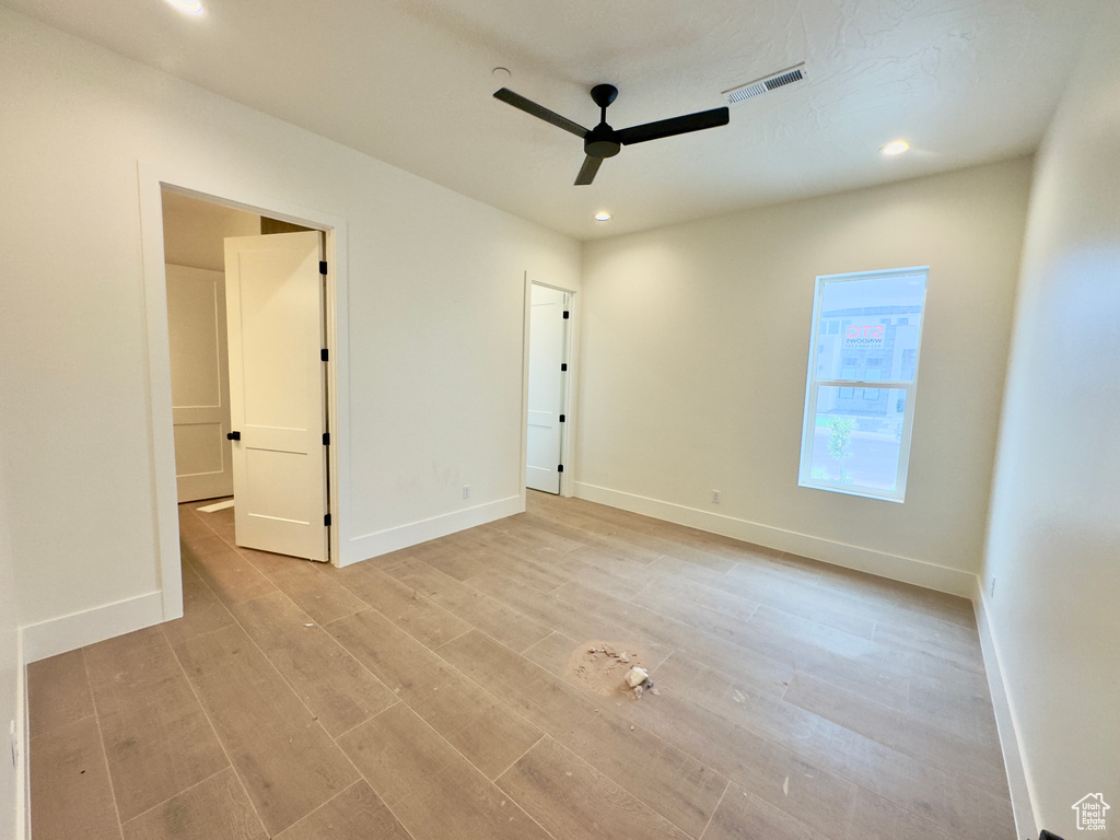 Unfurnished bedroom with light wood-type flooring and ceiling fan